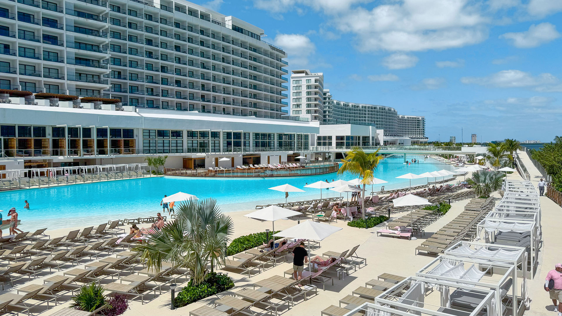 Crystal Lagoons lagoon at AVA Resort Cancun with white-sand beach and hotel towers along the AVA Resort Cancun lagoon shoreline, Cancun, Mexico