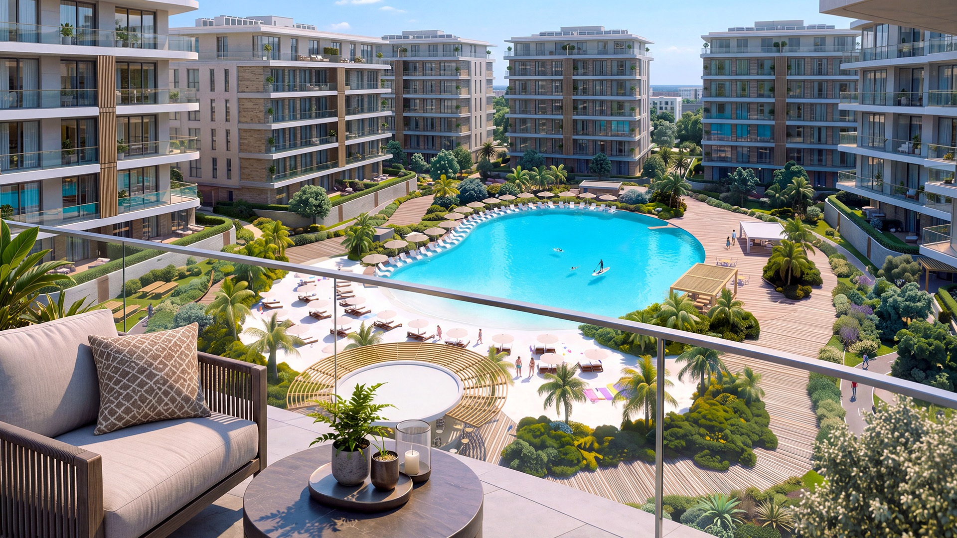 Balcony view of a turquoise lagoon surrounded by gardens and residential buildings