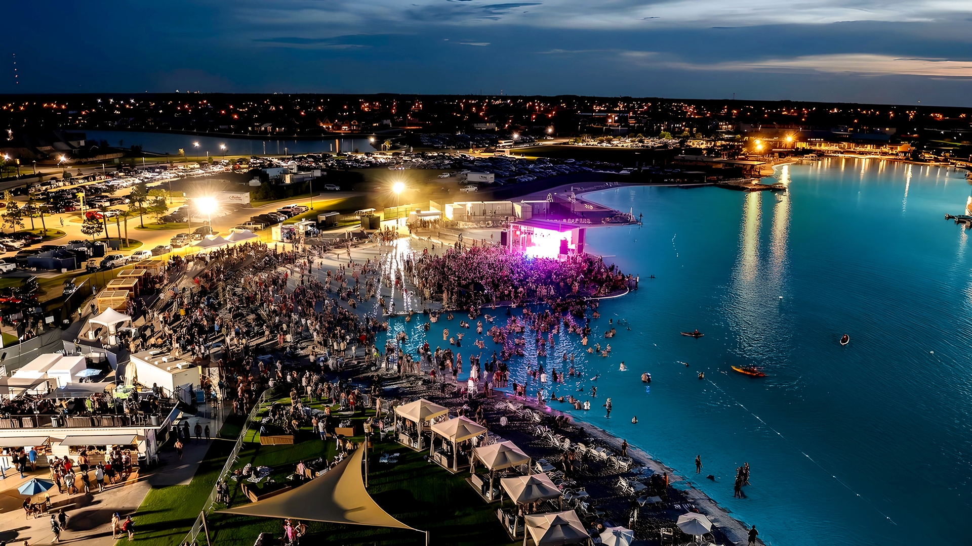 Nighttime concert with stage lights on the shore of a PAL® lagoon