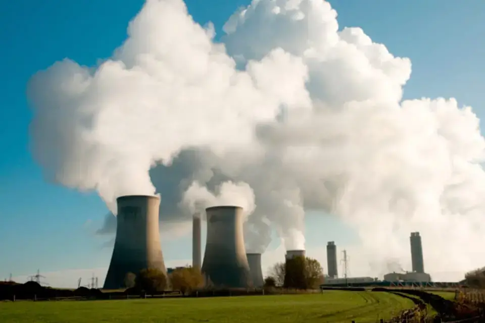 Wet cooling towers at a thermal power plant releasing large steam plumes into the atmosphere