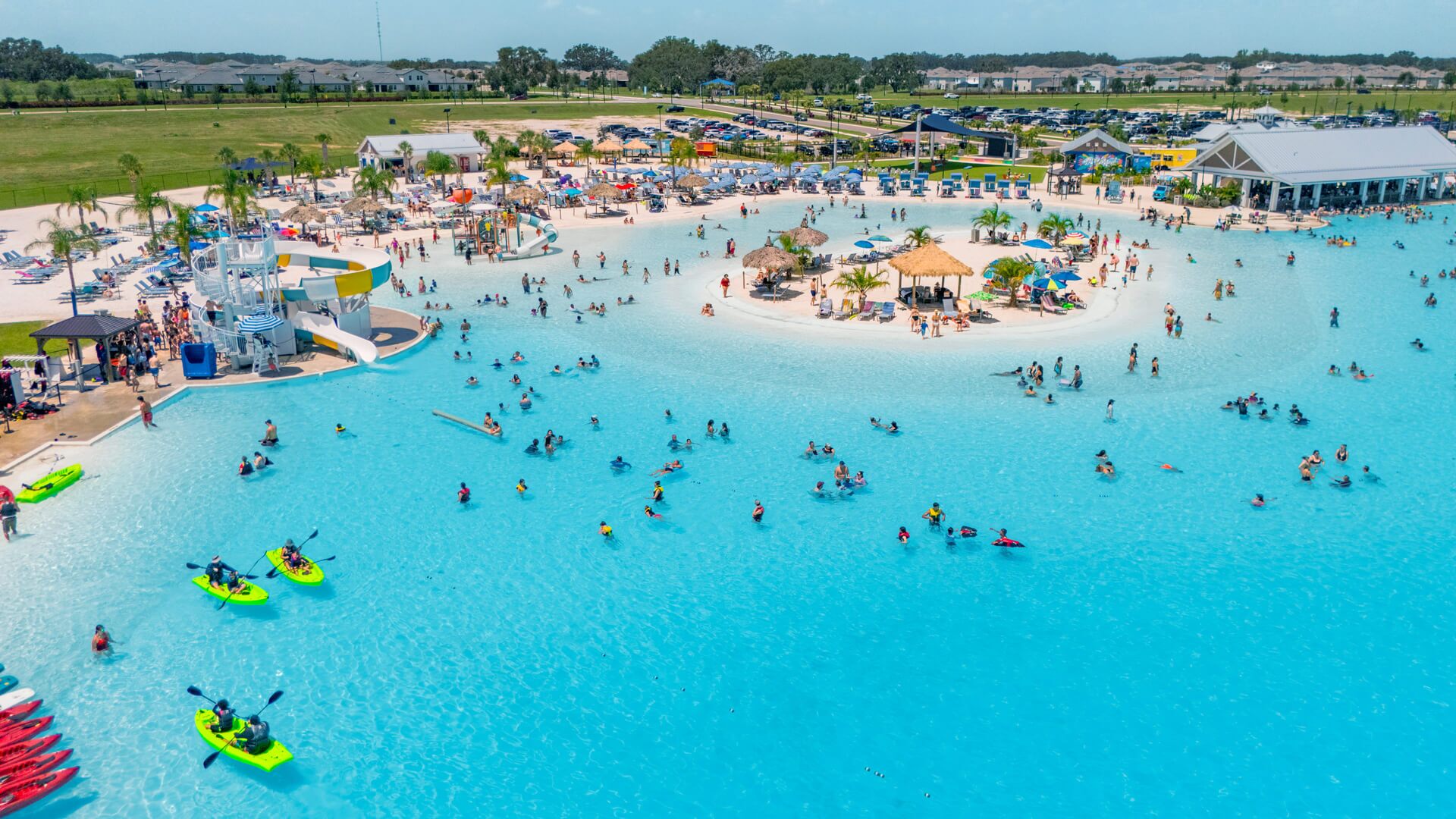 Aerial view of the Mirada lagoon in Florida with kayaks, water slides, and a floating playground